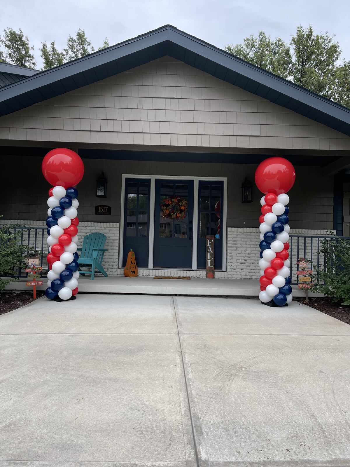 Red white and blue patriotic balloon columns on a front porch