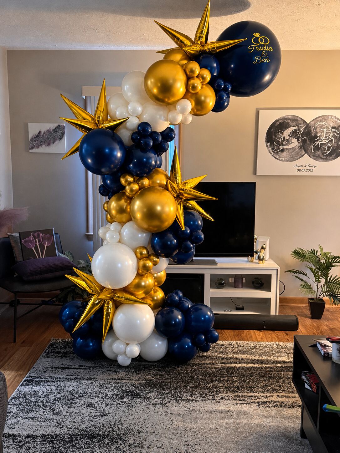 Navy, gold, and white organic balloon garland over a doorway